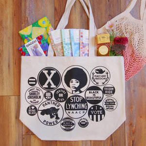 Black power Button totebag with chocolate and other items pouring out