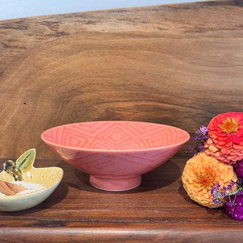 peach bowl with a dark peach graphic 